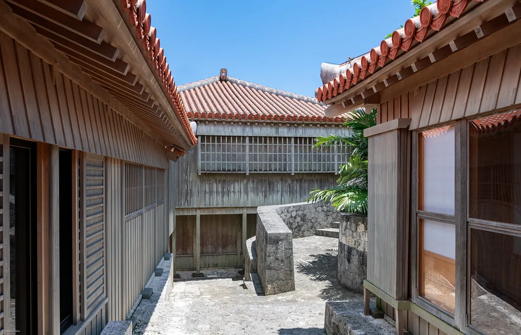 Busy Kokusai Street in Naha with colorful shop signs and pedestrians browsing souvenir stores