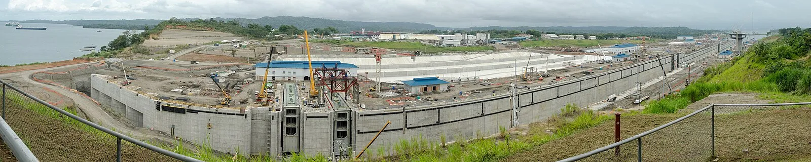 Panama Canal lock expansion construction panorama with cranes and concrete lock chambers