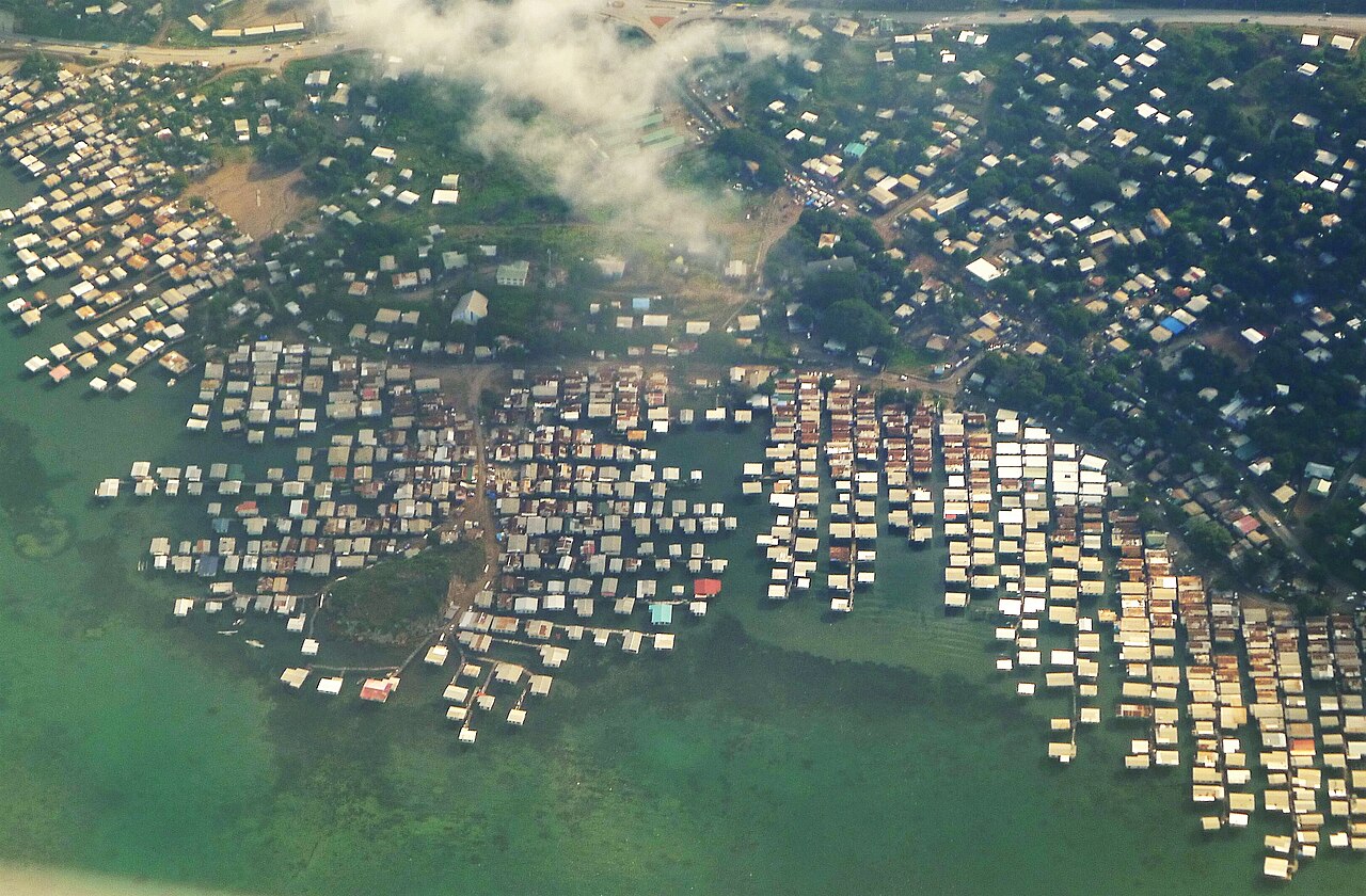 Aerial view of stilt village over turquoise water near Port Moresby