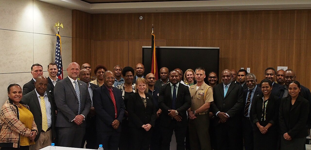 Panoramic view of Port Moresby harbor with mountains rising behind the Coral Sea coastline