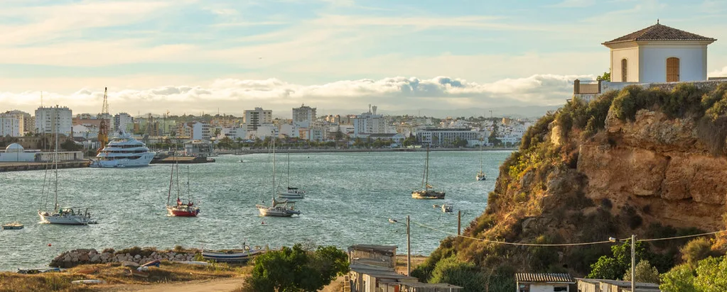Golden cliffs and turquoise waters along the Algarve coast near Portimão, Portugal