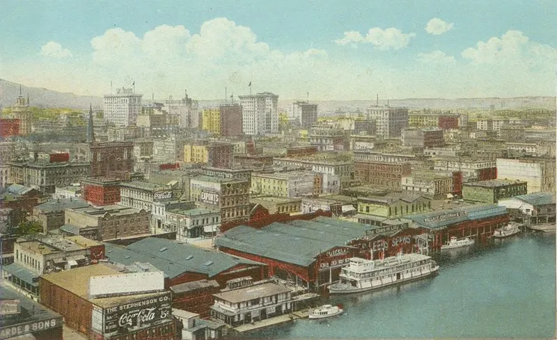 Hand-tinted postcard of Portland waterfront with Coca-Cola sign and steamboats on the Willamette River