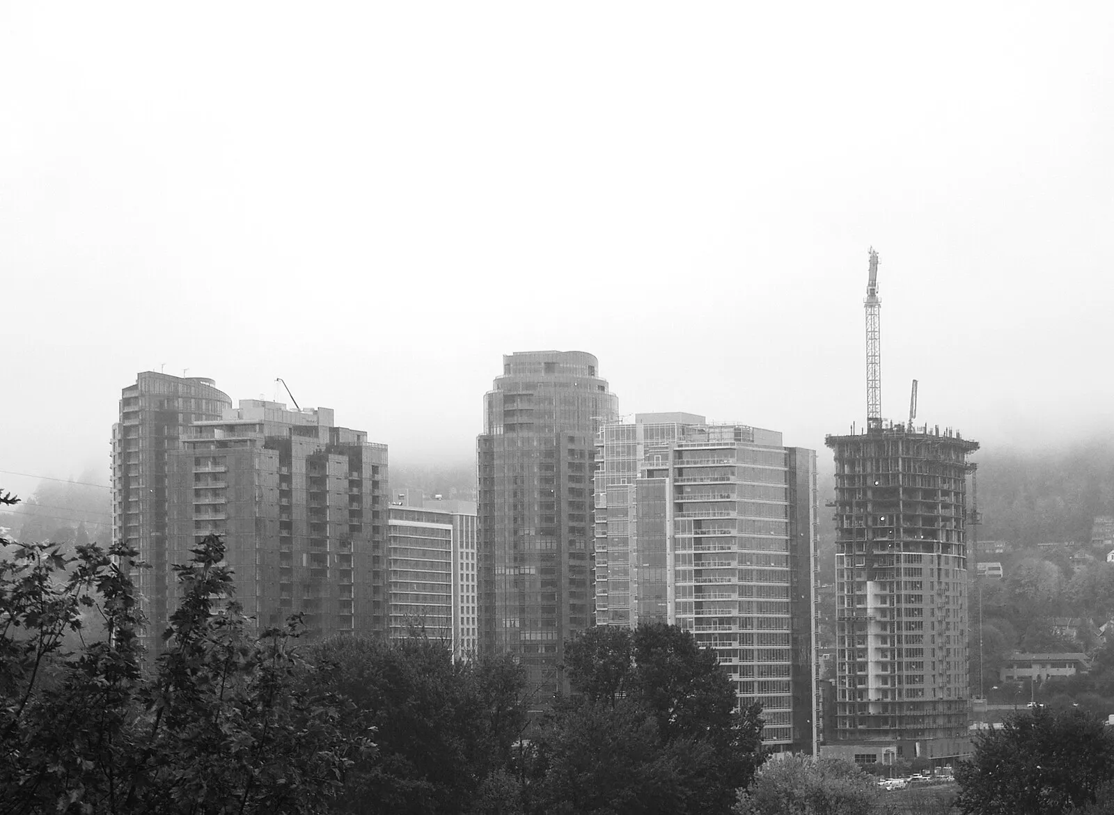 Portland Bill Lighthouse standing tall against dramatic Dorset skies with waves crashing on the rocky shoreline below