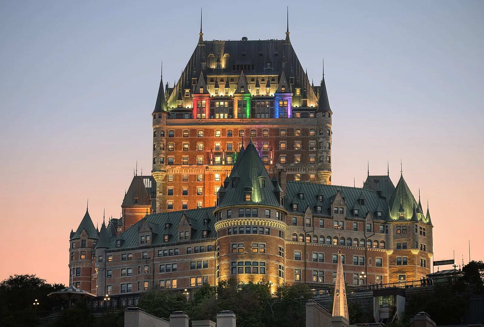 Château Frontenac illuminated at night with the Old Quebec funicular