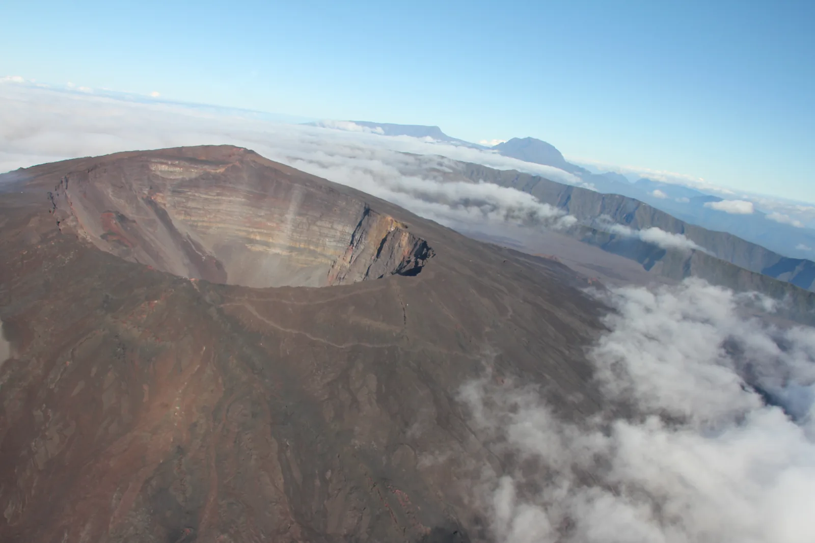 The crater of Piton de la Fournaise photographed from a helicopter, showing the dark cone and caldera floor