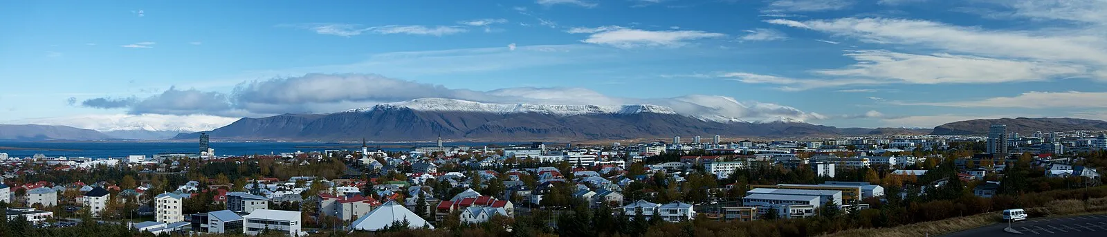 Elevated panoramic of Reykjavik with snow-capped mountains and autumn colours