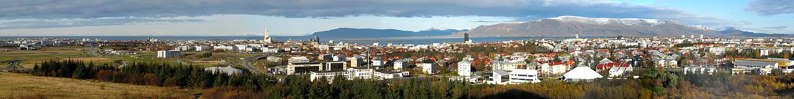 Wide panoramic of Reykjavik with Hallgrímskirkja church and mountains