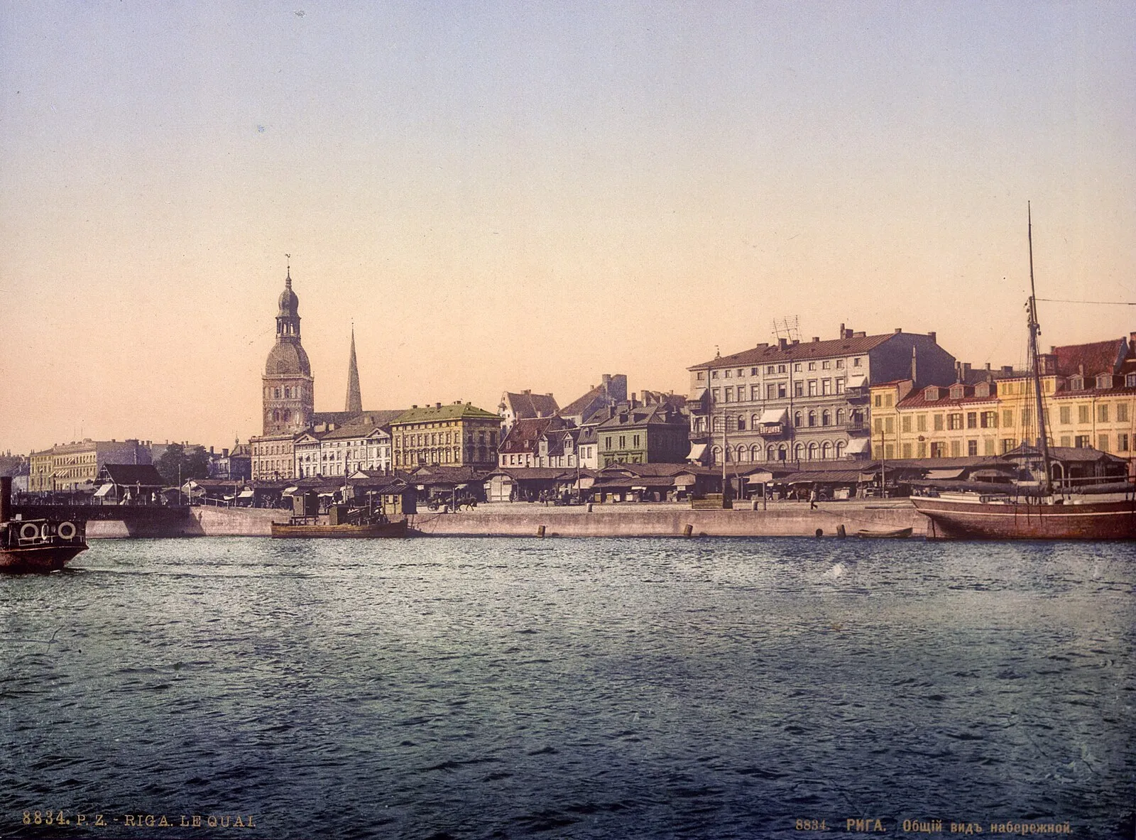 Historical photochrom of Riga quayside, c. 1890s, showing sailing vessels along the Daugava