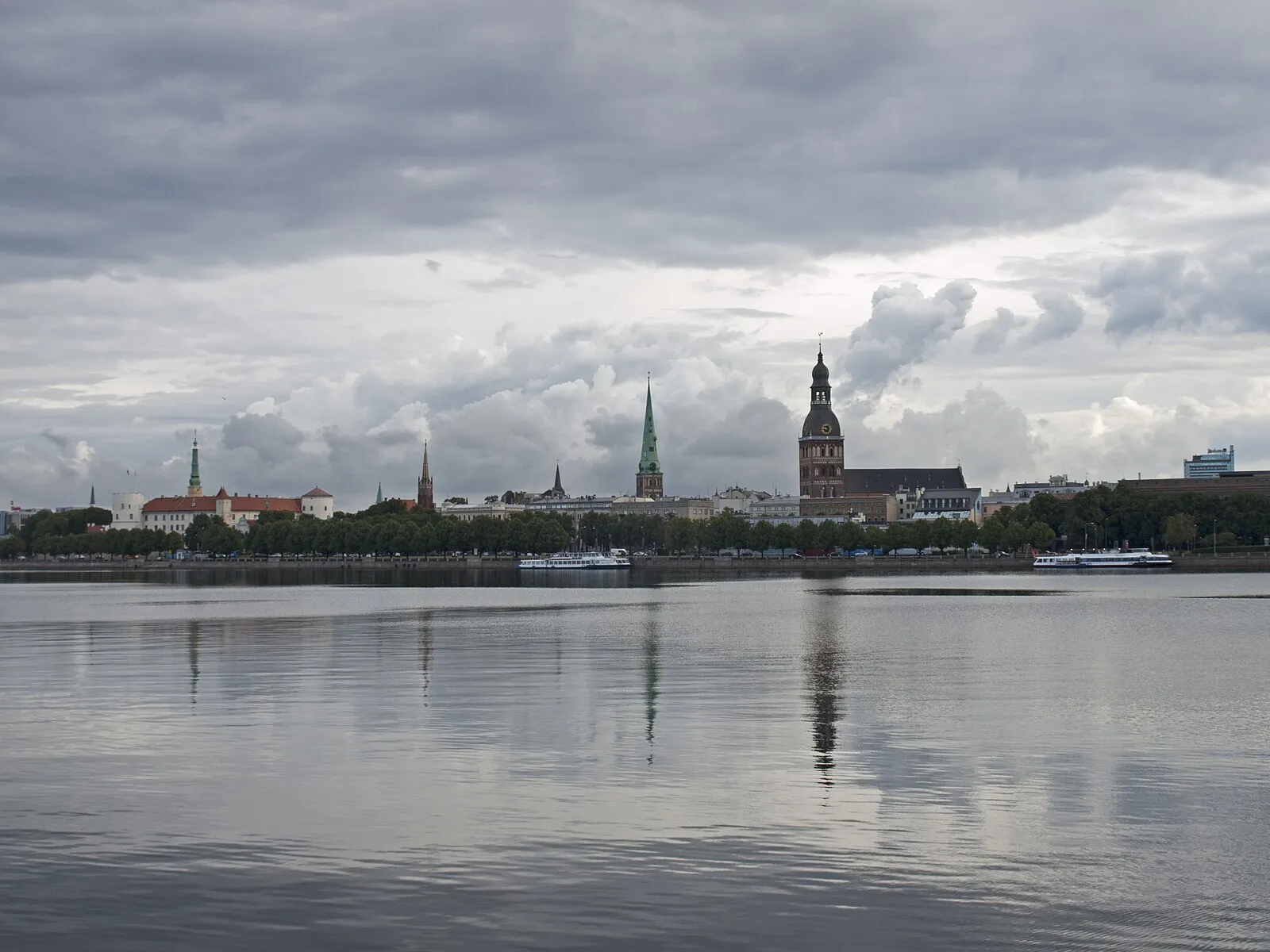 Water-level view of Riga skyline with church spires reflected in the Daugava