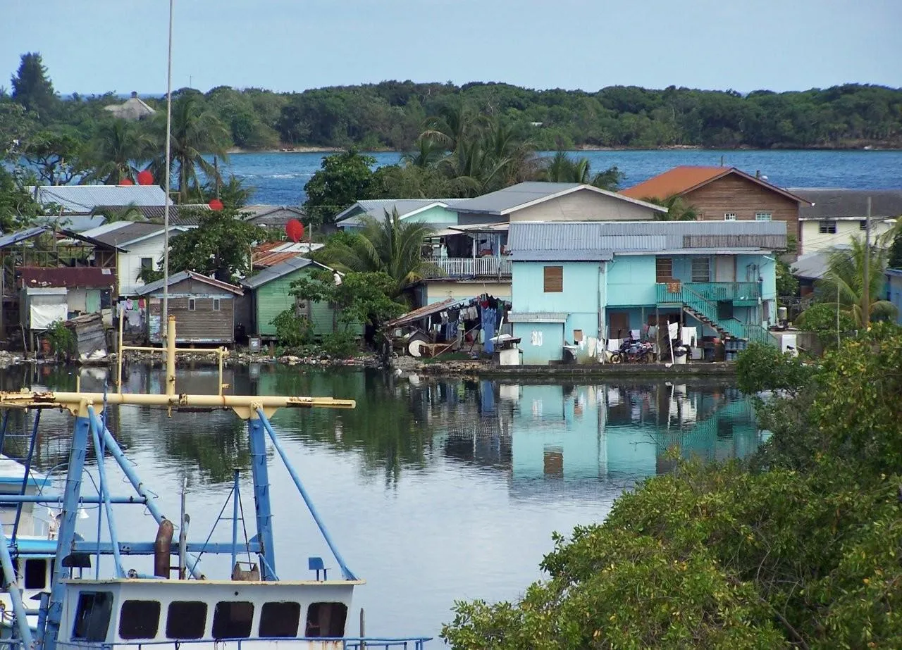 Traditional fishing village on Roatan's coastline with colorful wooden houses on stilts