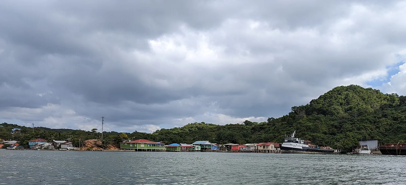 Coastal village on Roatan with palm trees and turquoise Caribbean waters