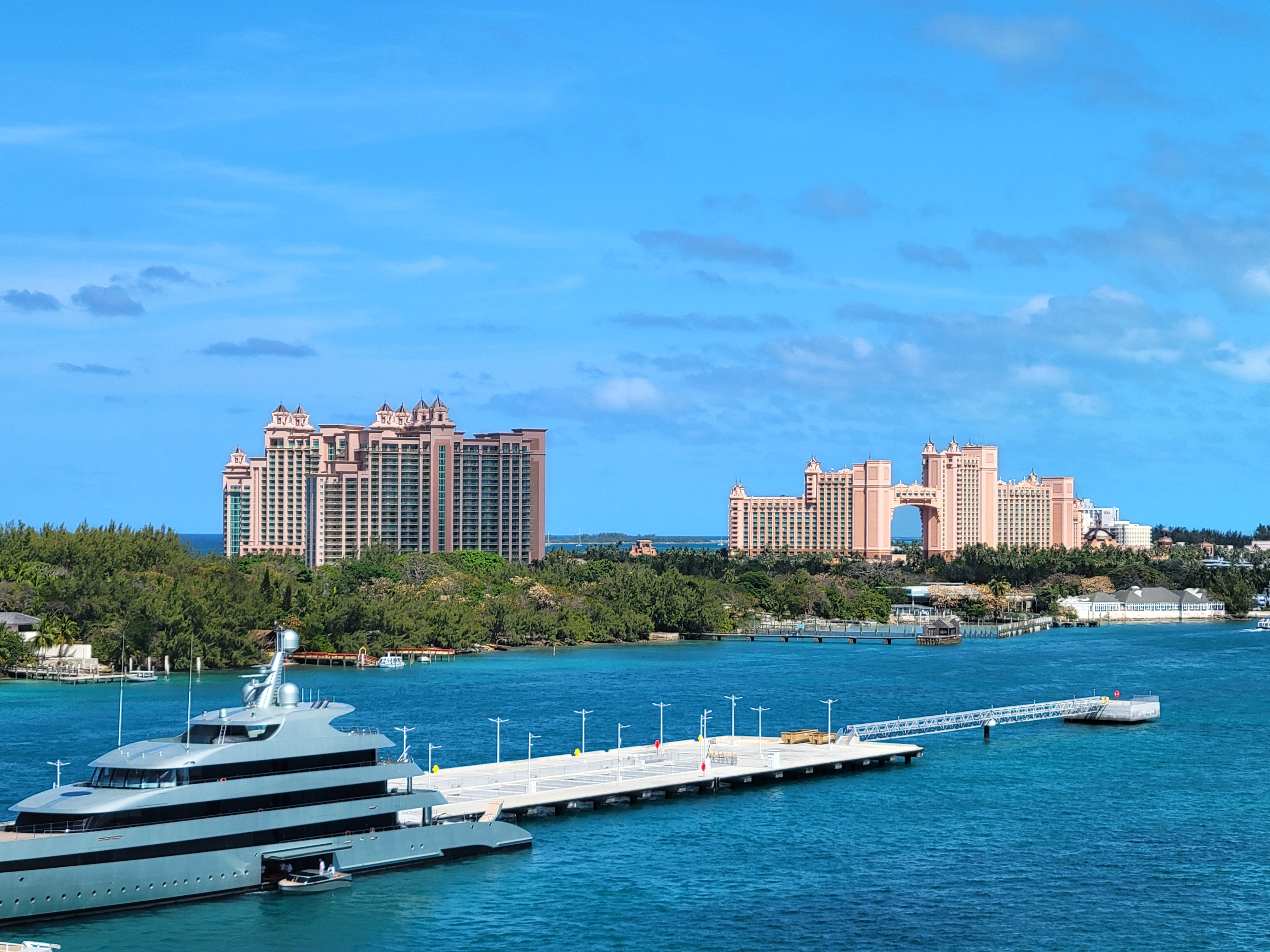 Freshwater pool with swim-up bar surrounded by loungers and palm trees