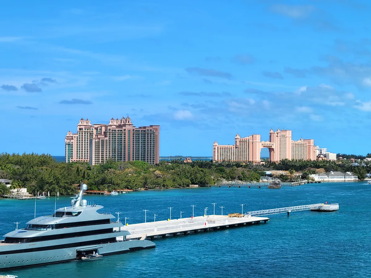 Freshwater pool with swim-up bar surrounded by loungers and palm trees