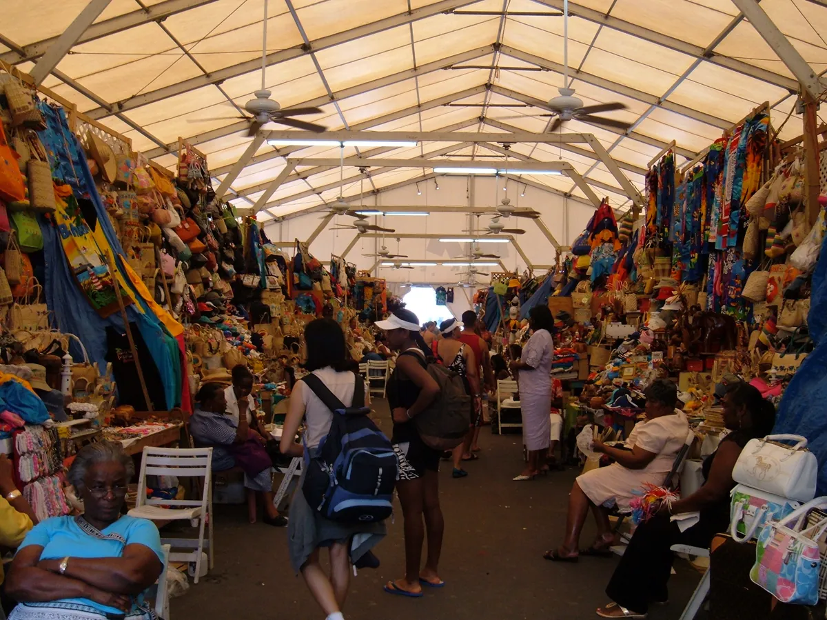 Bahamian artisan weaving traditional straw basket at cultural village
