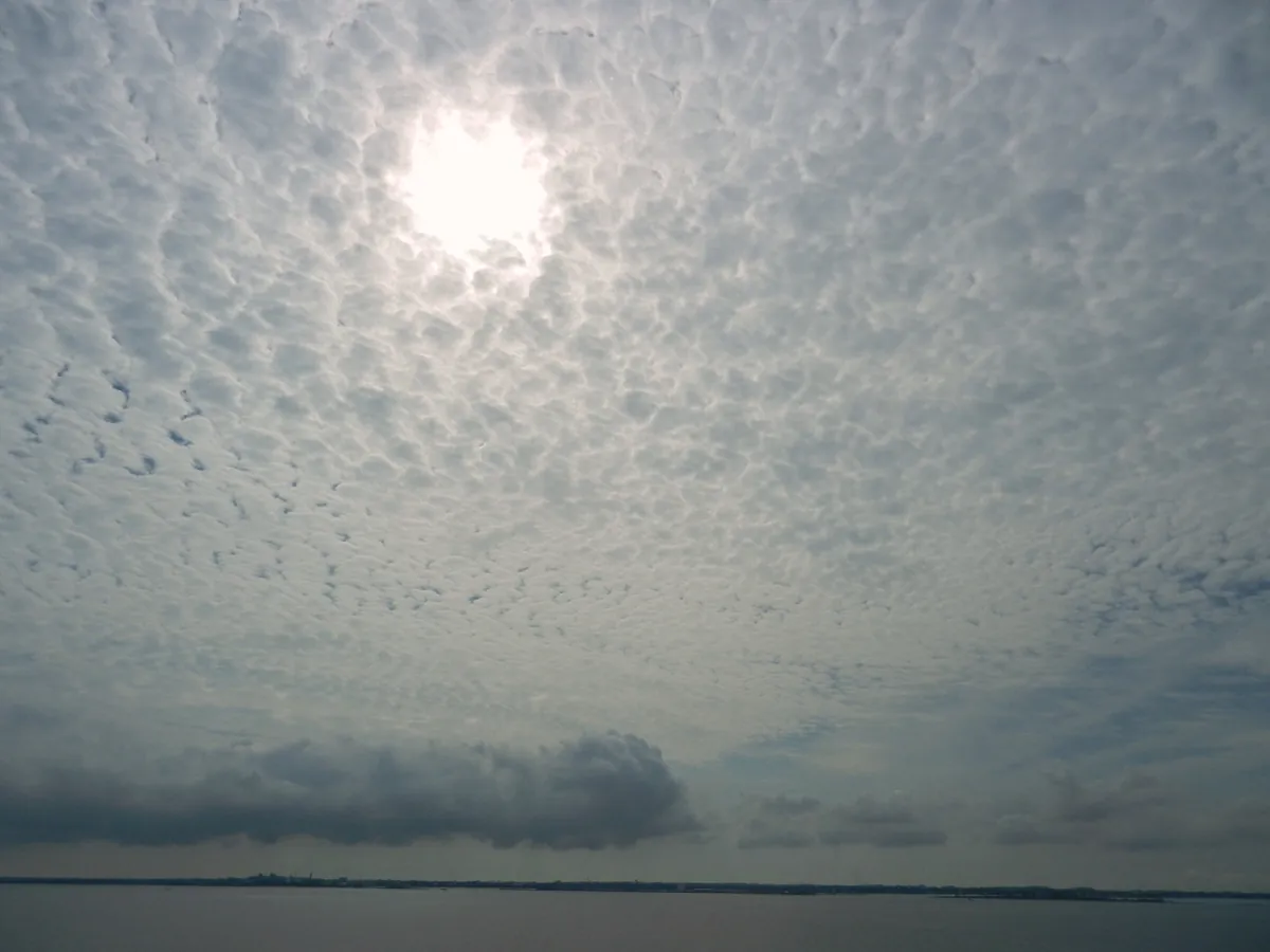 Children playing in shallow turquoise water building sandcastles