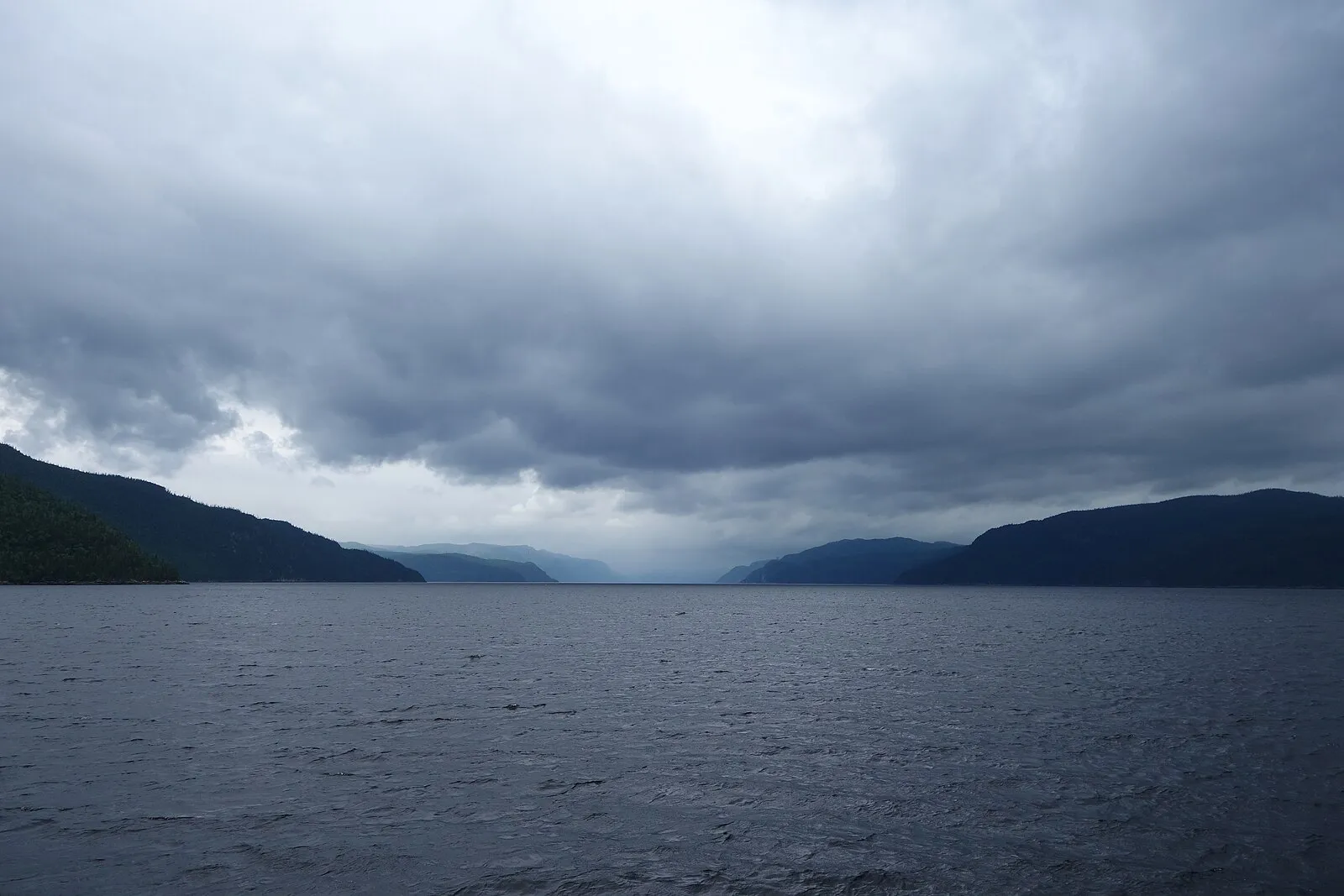 Saguenay Fjord viewed from the water, steep forested cliffs rising on both sides