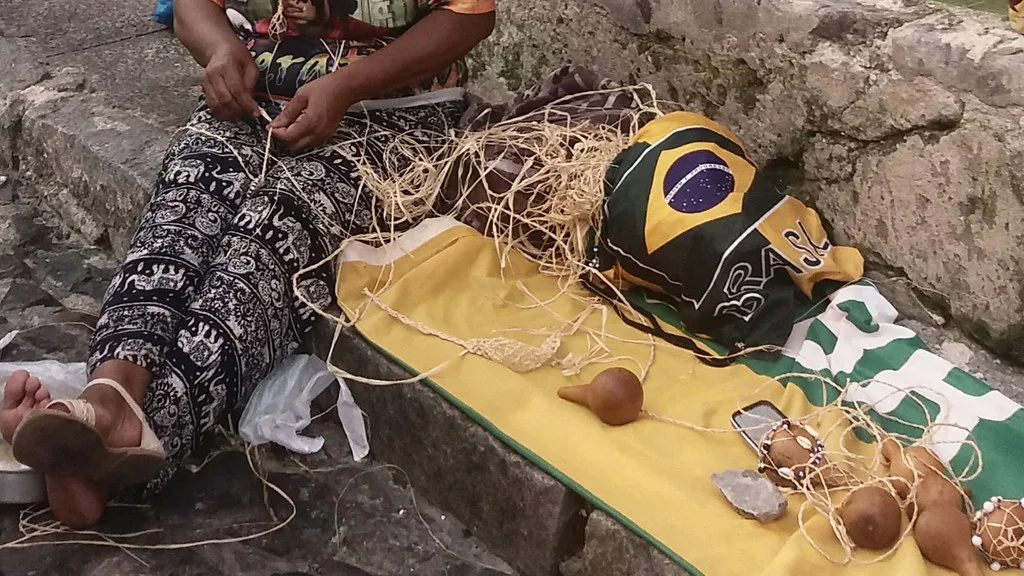 Aerial view of Salvador's Pelourinho historic district showing rows of colorful colonial buildings in blue, yellow, and pink along cobblestone streets