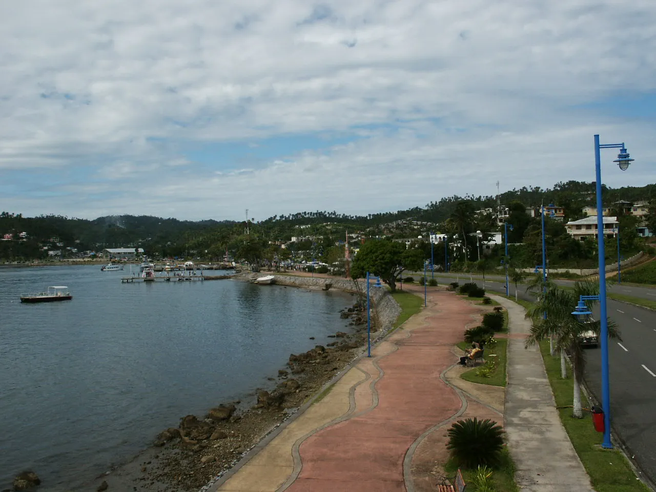 Limestone karst formations of Los Haitises National Park rising from emerald mangrove waters with cave entrances visible