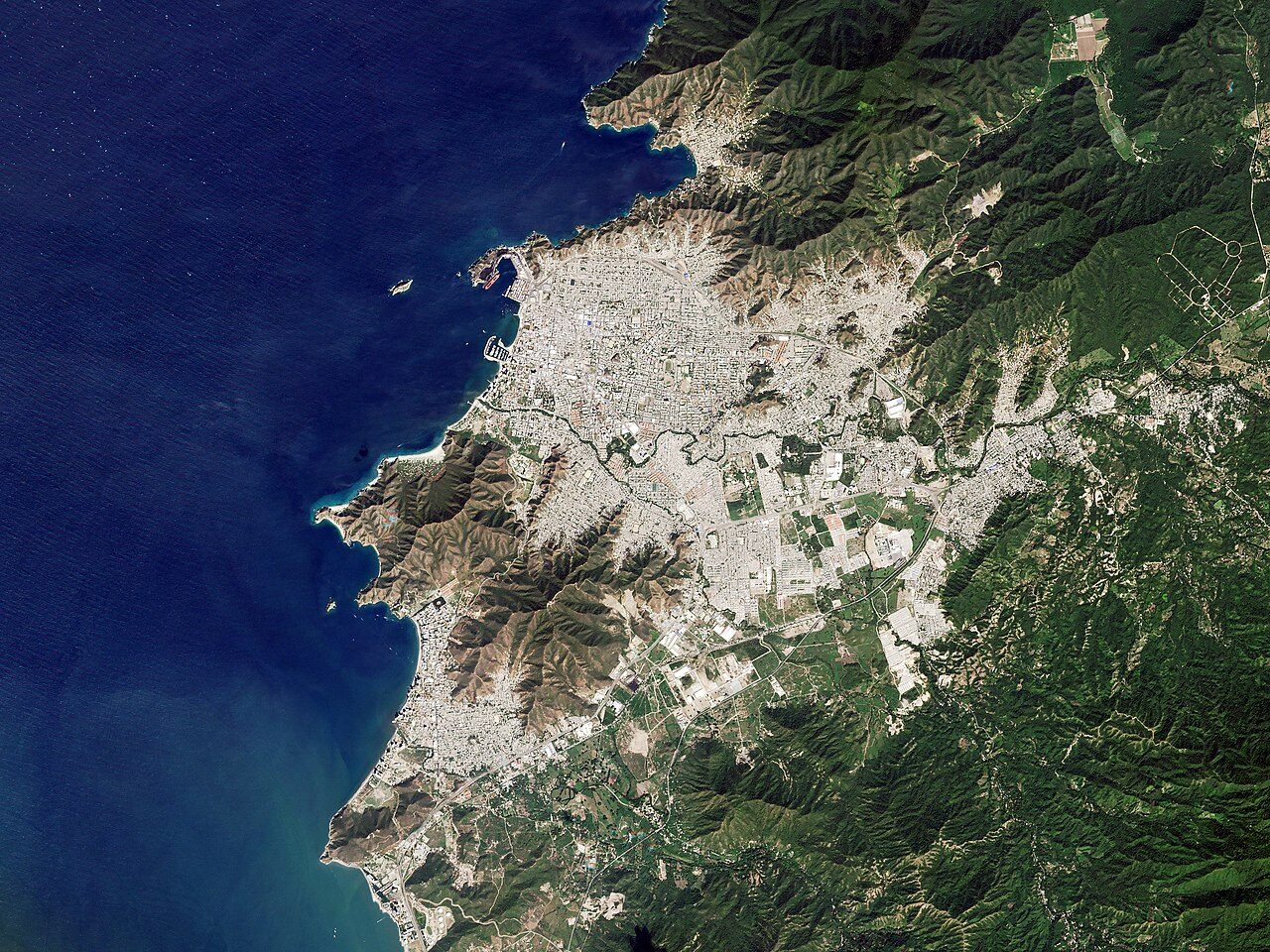 Satellite view of Santa Marta showing the city between the Sierra Nevada mountains and Caribbean Sea