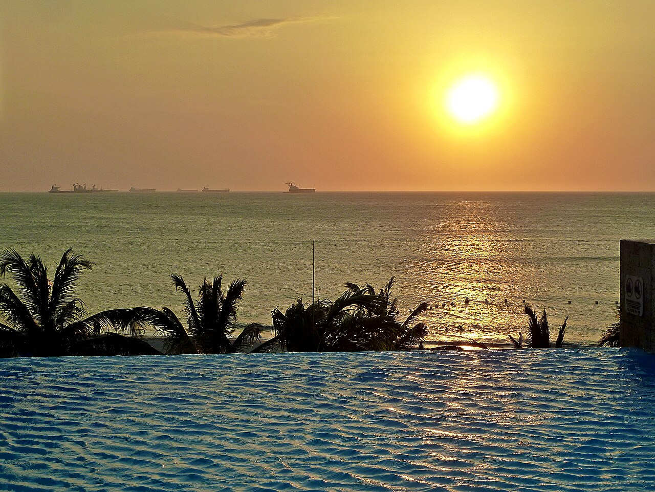 Caribbean sunset from an infinity pool overlooking the bay at Santa Marta