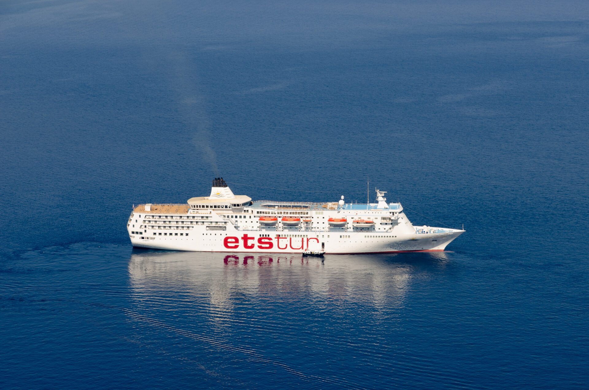 Etstur cruise ship anchored in the deep blue waters of Santorini's caldera