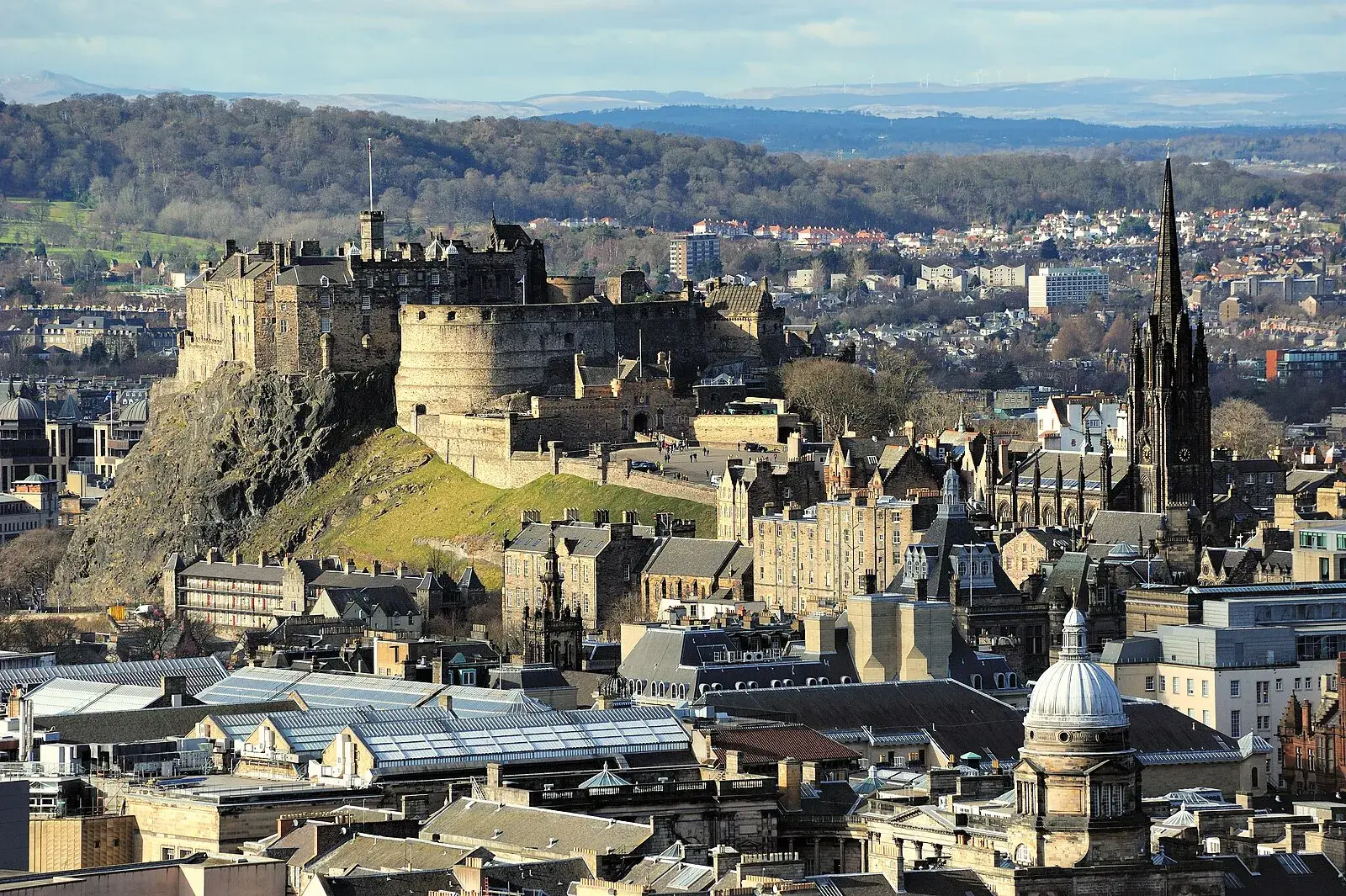 Edinburgh Castle panoramic view from distance showing the castle perched on volcanic rock above the city skyline
