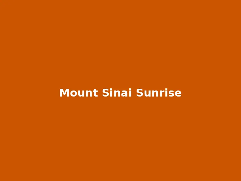 Spectacular sunrise viewed from the summit of Mount Sinai casting golden light across the desert mountains
