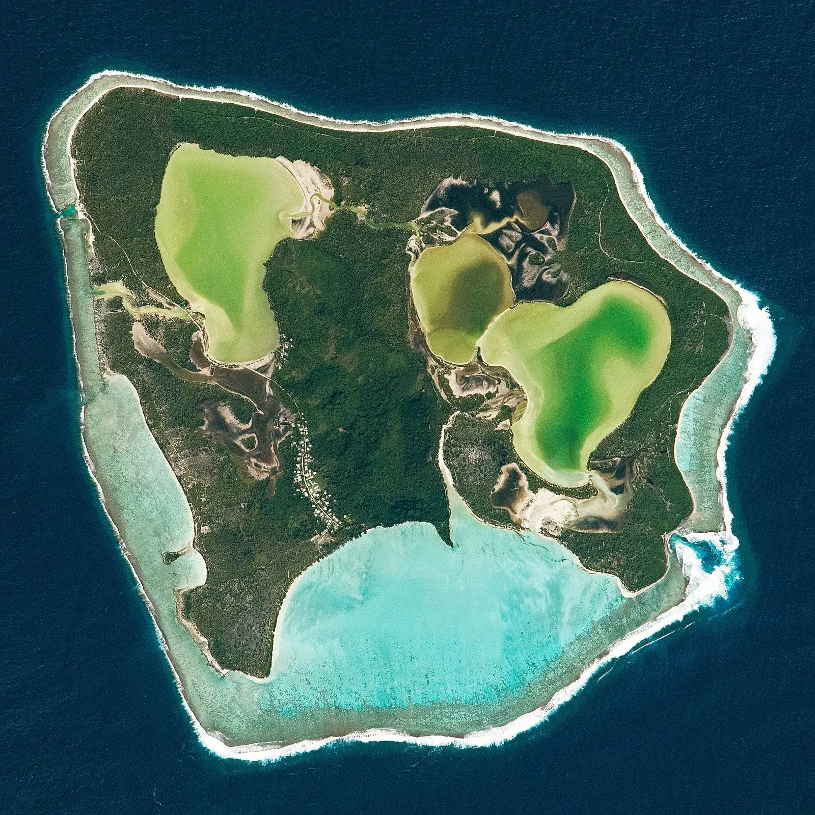 Satellite view of a South Pacific atoll with turquoise lagoons