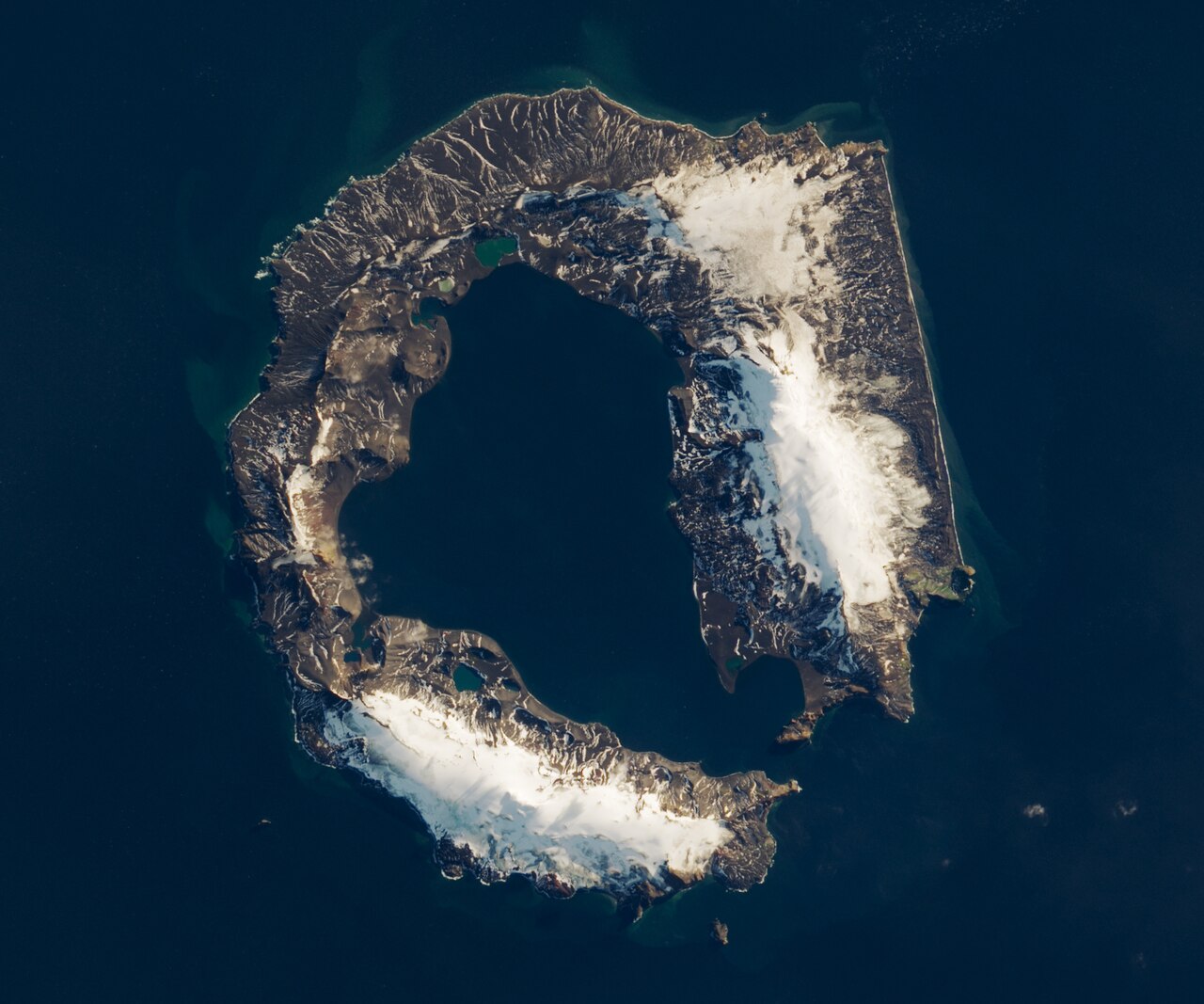 Satellite image of Deception Island showing the flooded volcanic caldera from space