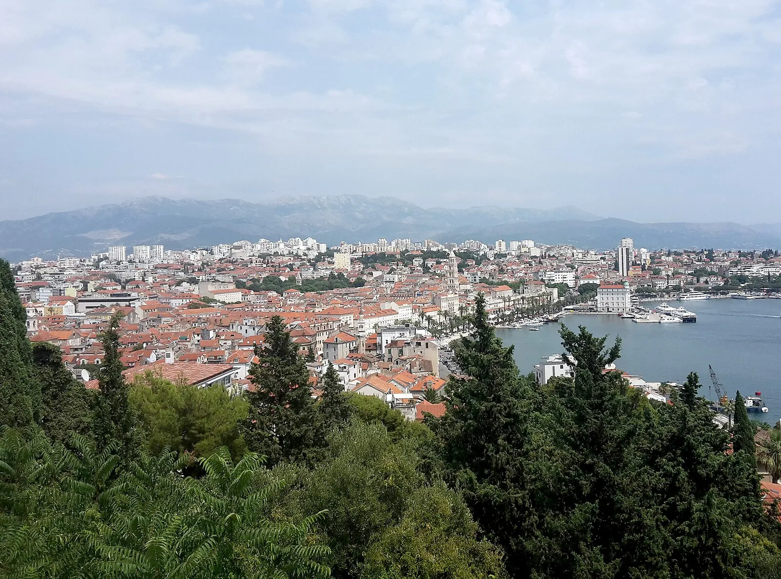 Panoramic view of Split from Marjan Hill showing red rooftops, harbor, and mountains behind