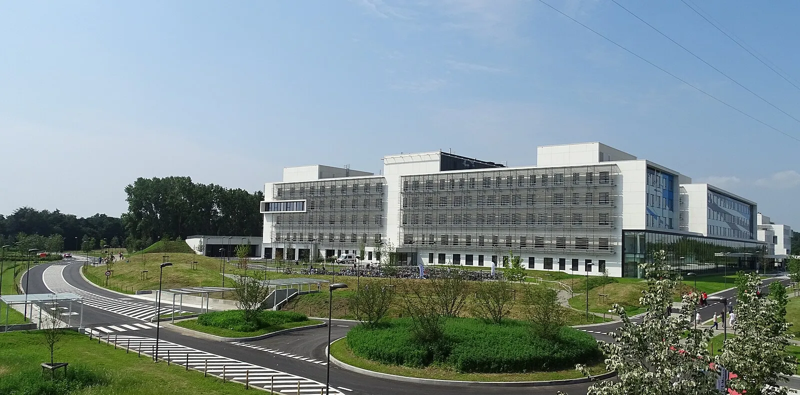 Airplane landing over Maho Beach with tourists watching from the sand