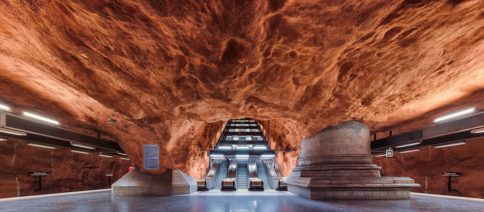 Stockholm metro Rådhuset station with dramatic carved-rock ceiling in orange and red