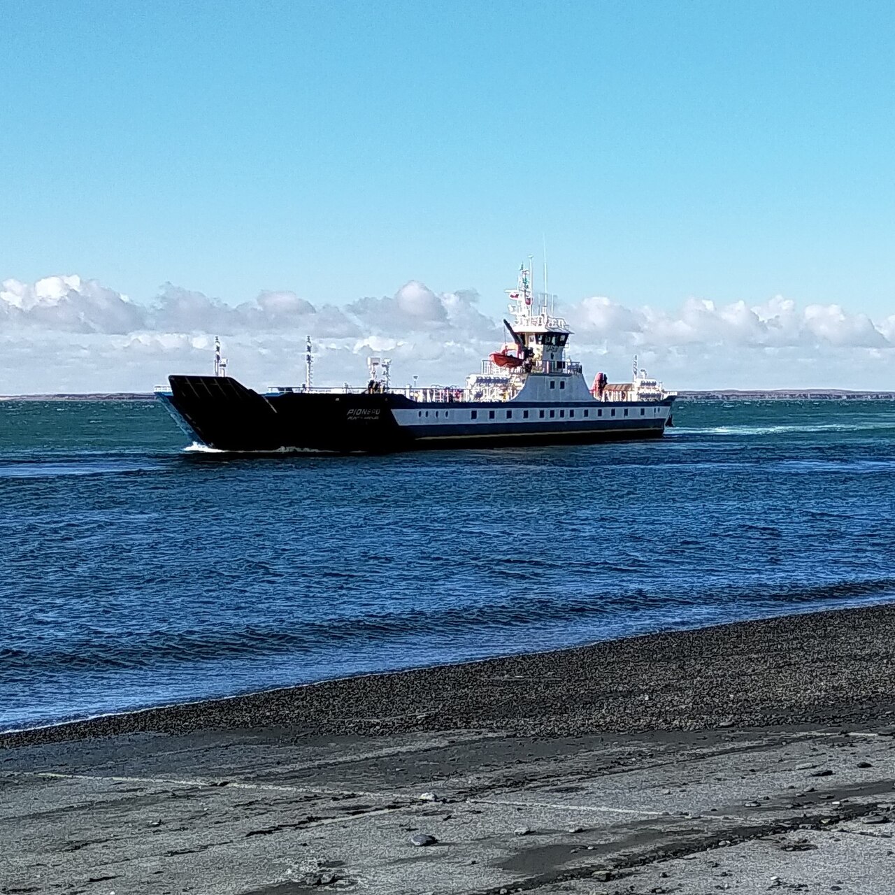 Ferry crossing the Strait of Magellan with Tierra del Fuego visible in the distance