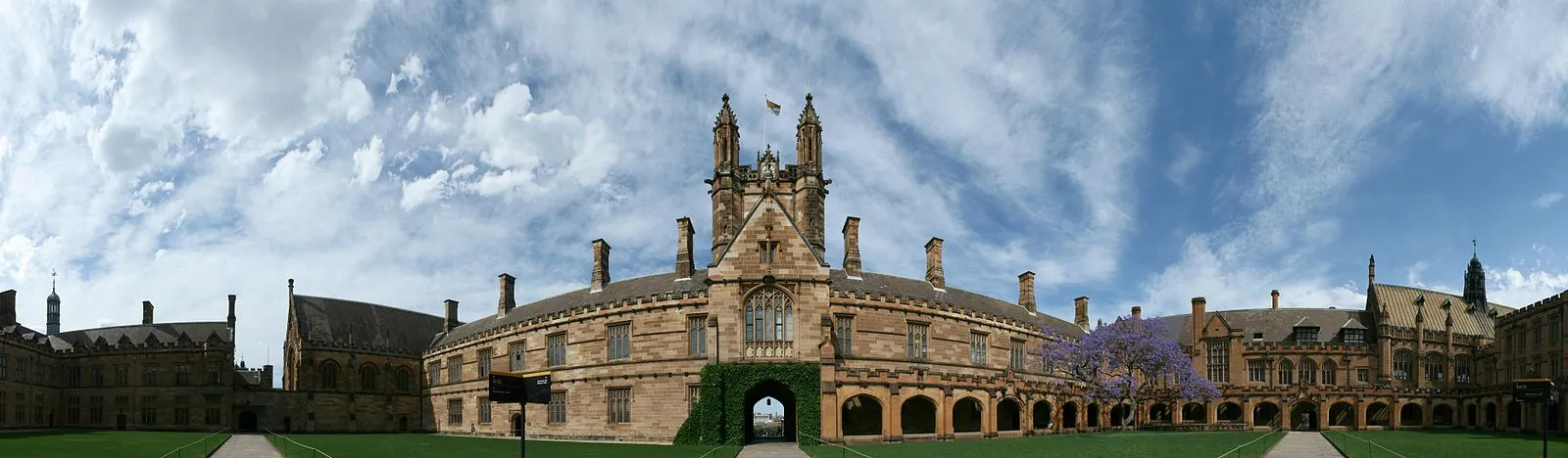 University of Sydney quadrangle with Gothic Revival architecture and jacaranda tree