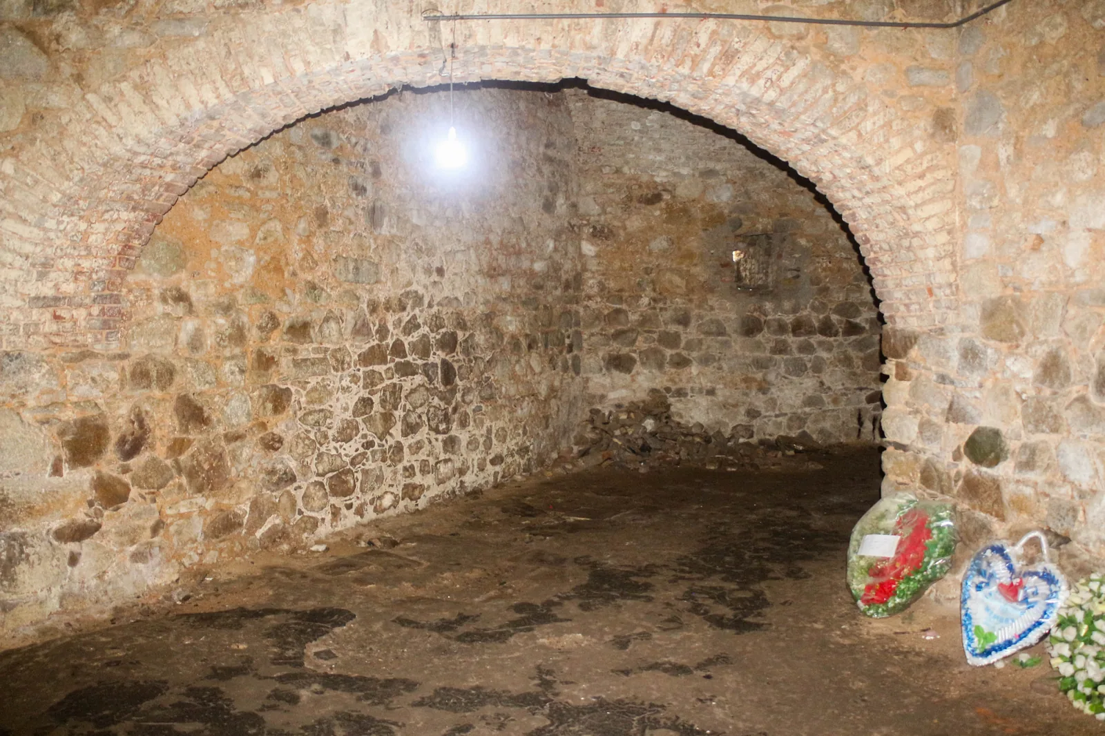 Inside the female slave dungeons at Cape Coast Castle, bare stone walls and a low ceiling