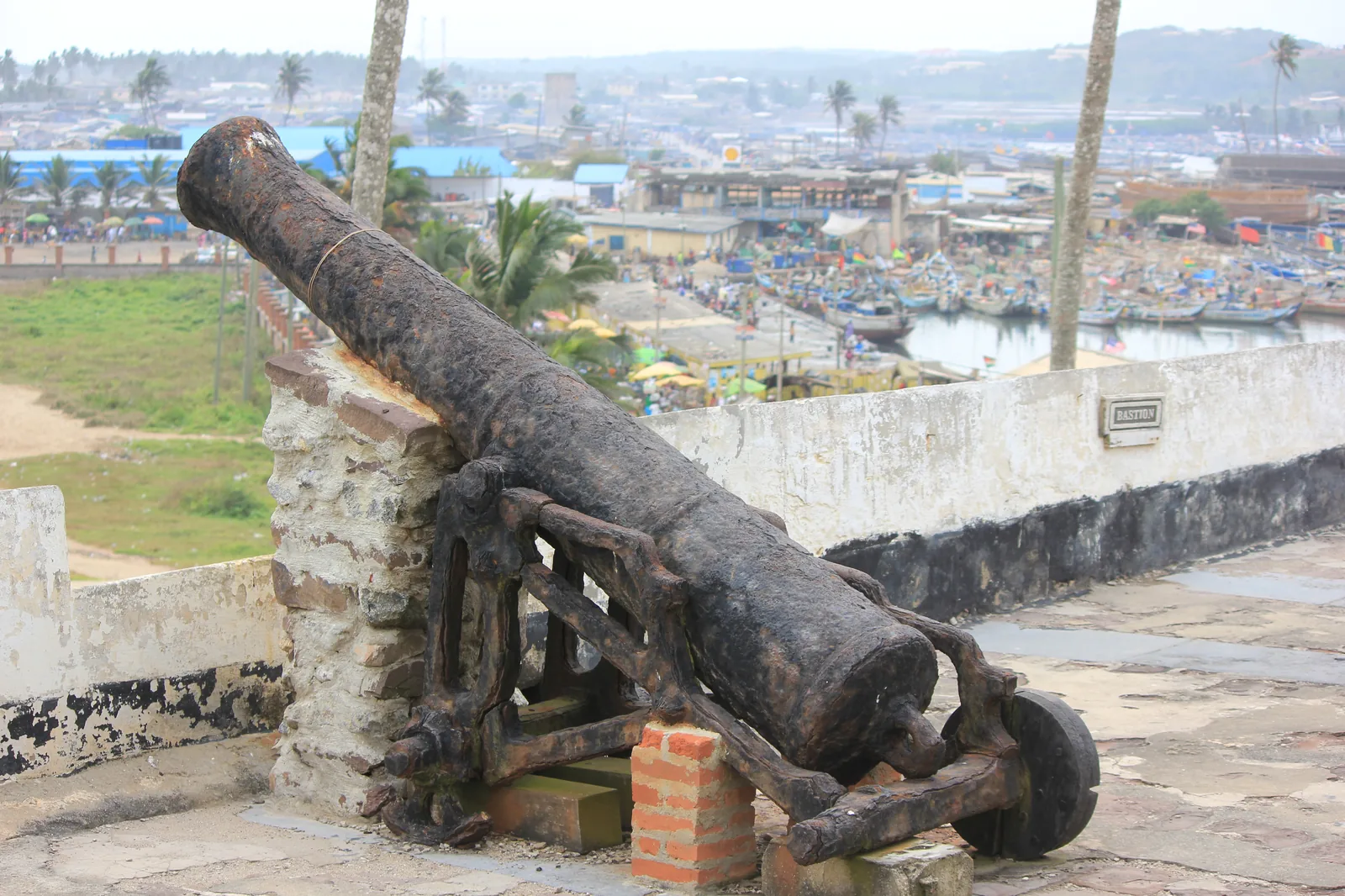 Cannon on the ramparts of Elmina Castle looking out over the town and its fishing port