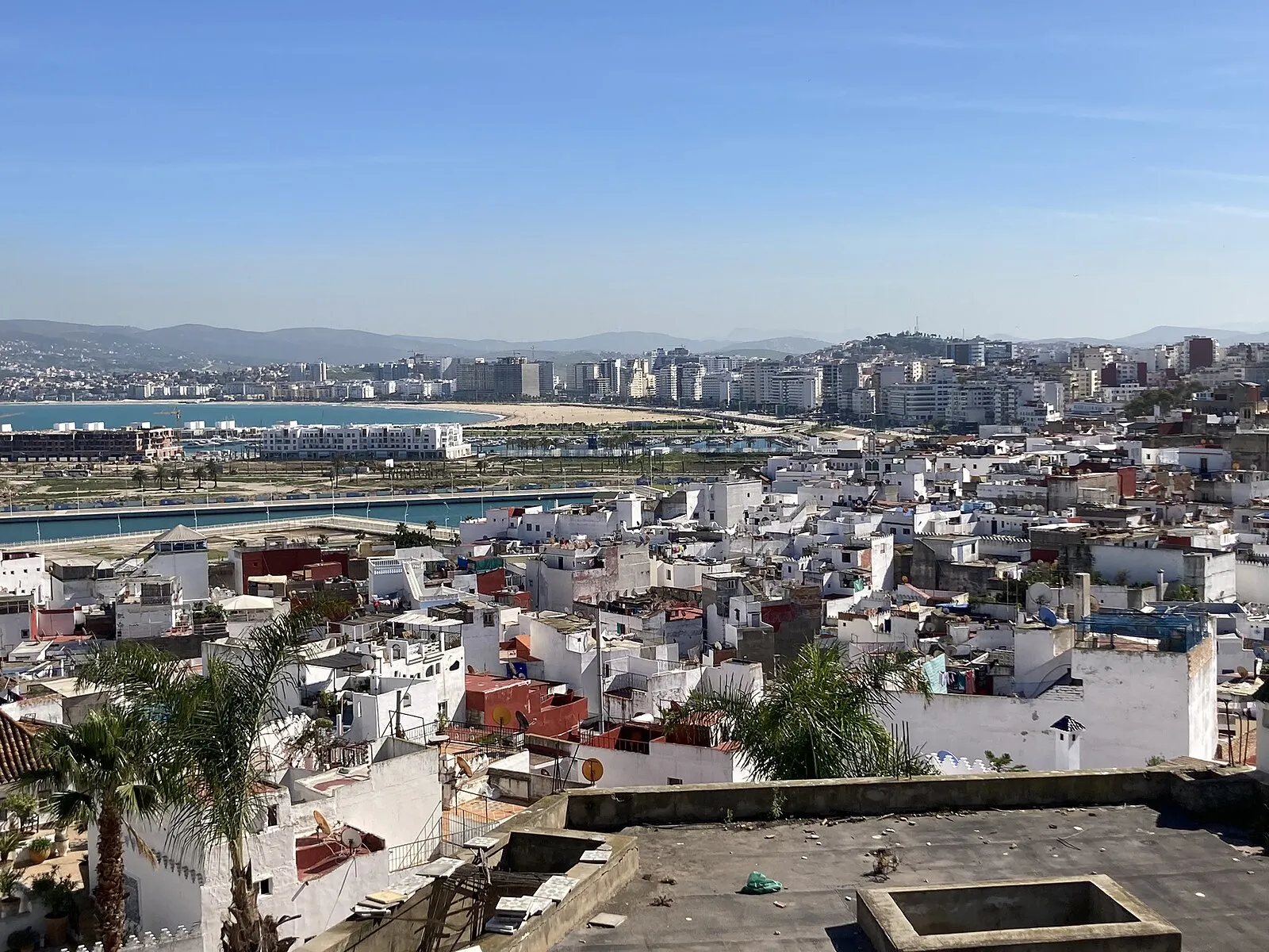 Panoramic view from Tangier medina over white-washed rooftops to port and bay