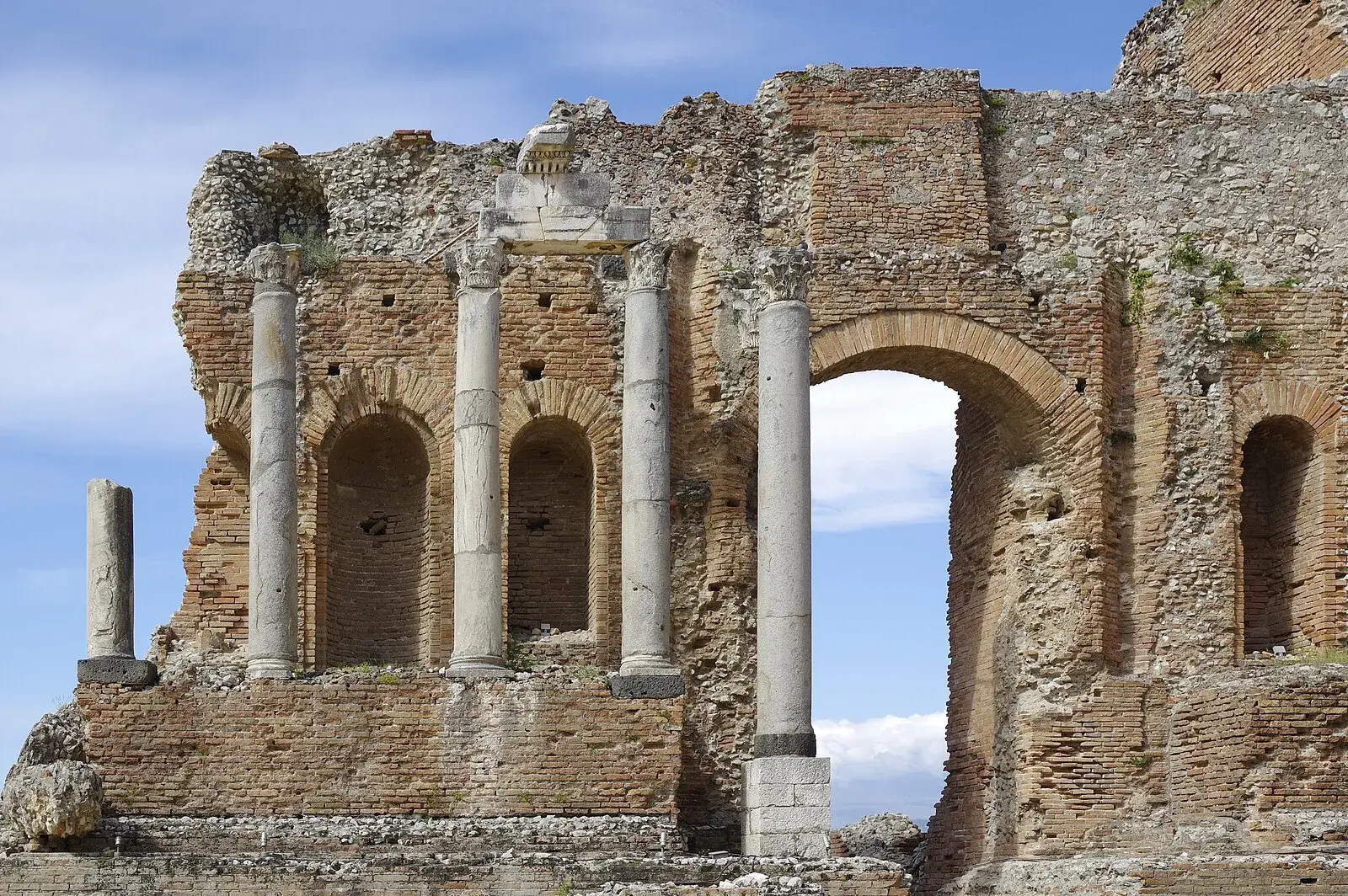 Close-up of Teatro Greco scaenae frons stage wall with ancient columns and arches