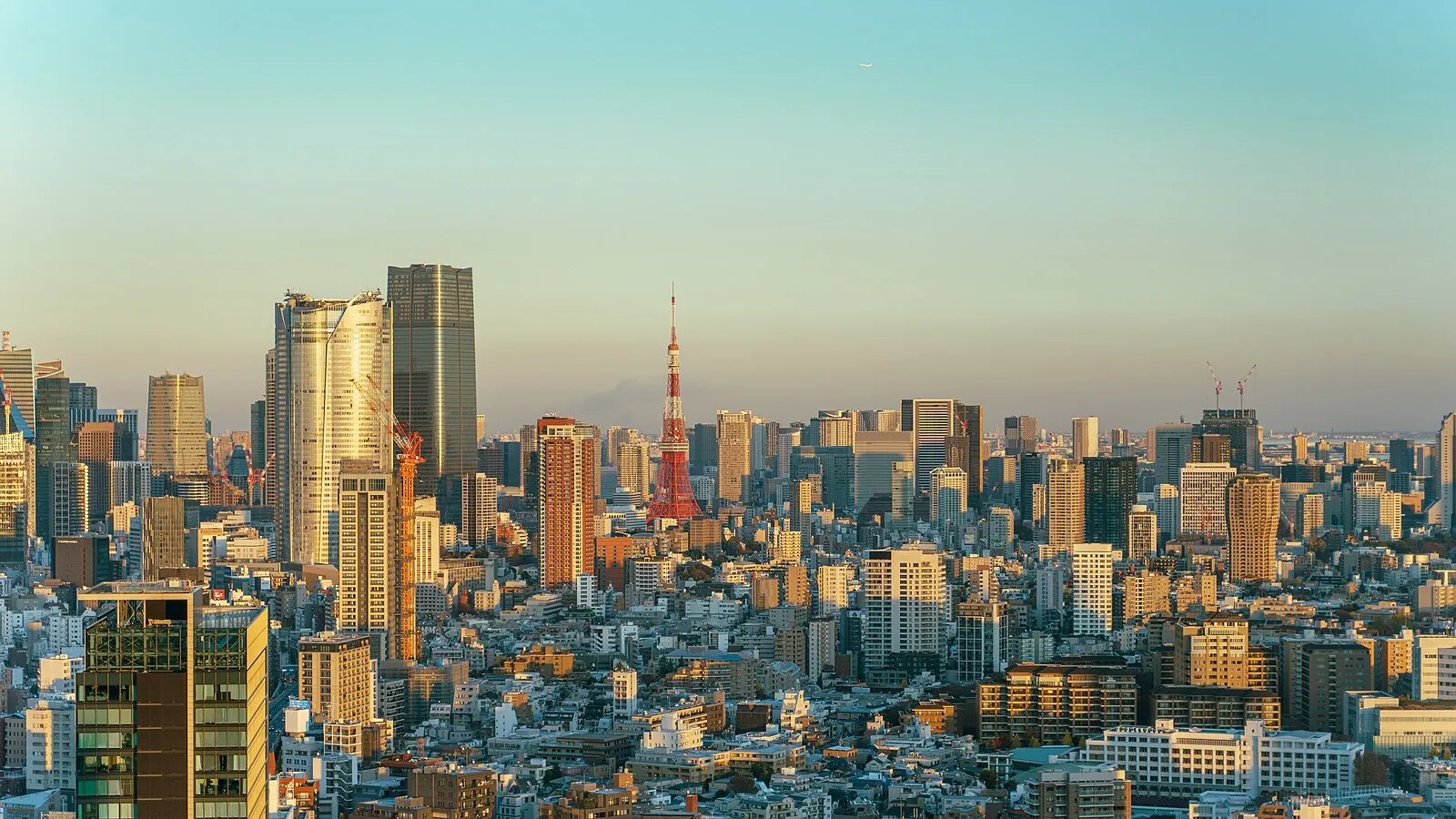 Tokyo skyline at golden hour with Tokyo Tower and modern skyscrapers including Roppongi Hills