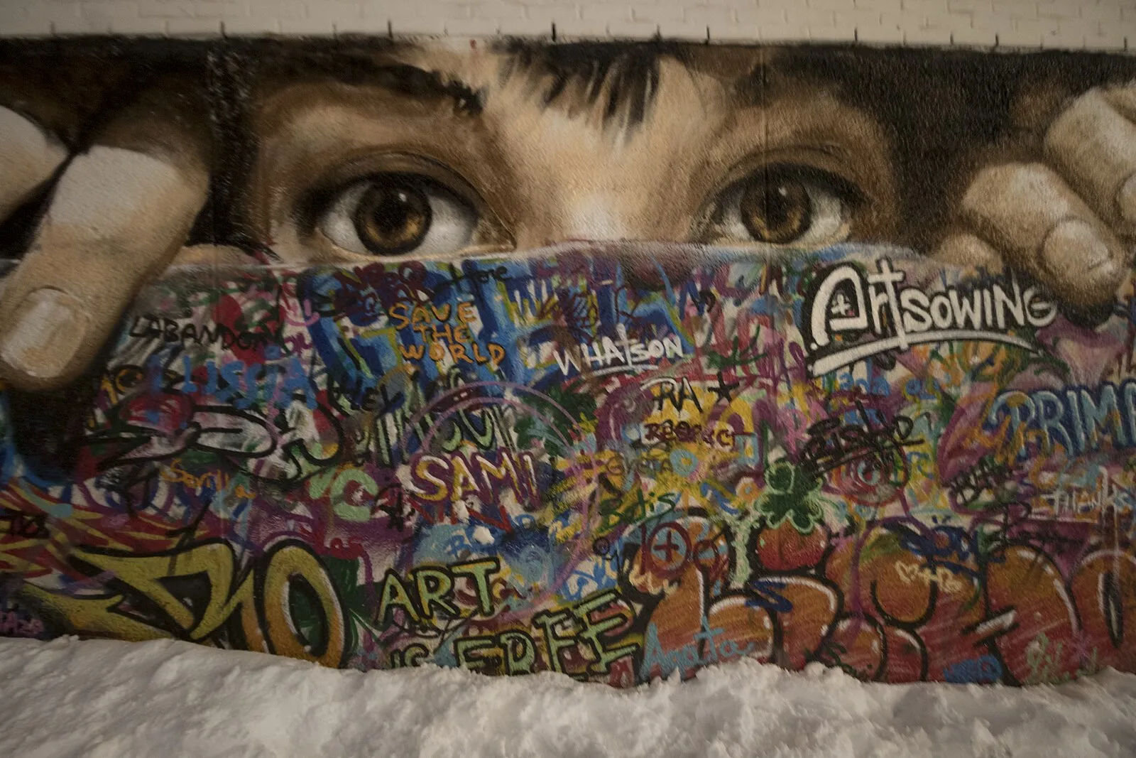 Midnight sun casting golden light over Tromsø fjord with mountains silhouetted against the glowing horizon