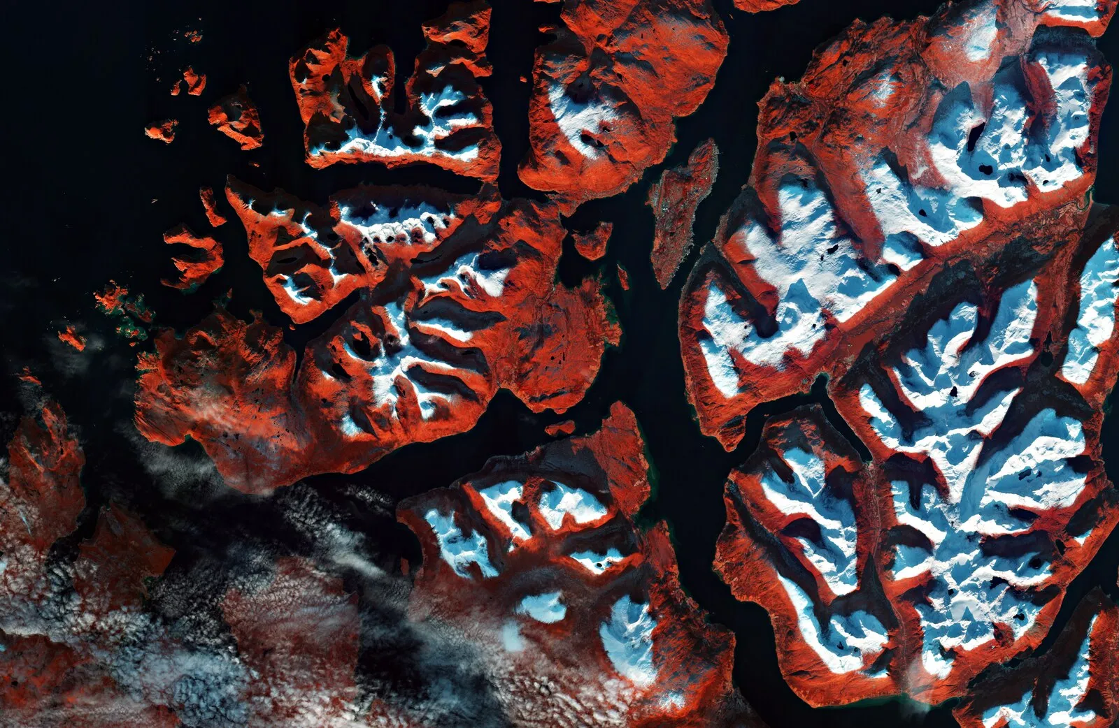 Northern lights aurora borealis dancing in green and purple curtains above the Tromsø Bridge and Arctic Cathedral at night