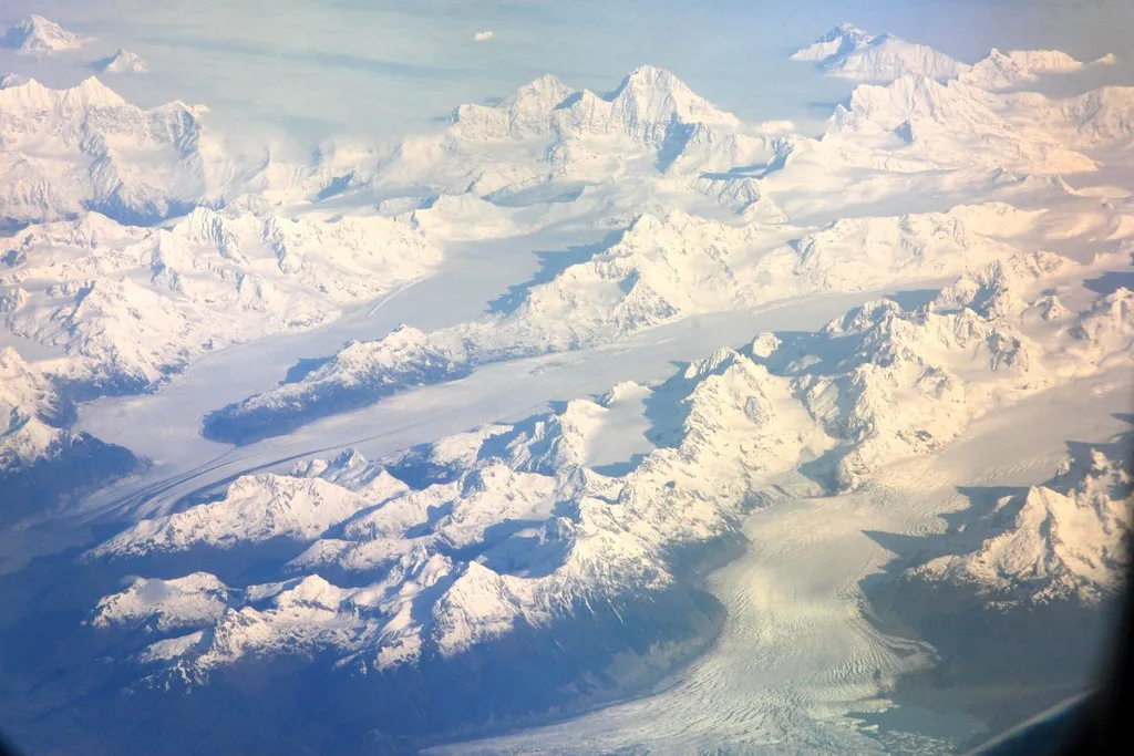 Mountain peaks breaking through clouds near Valdez with dramatic light