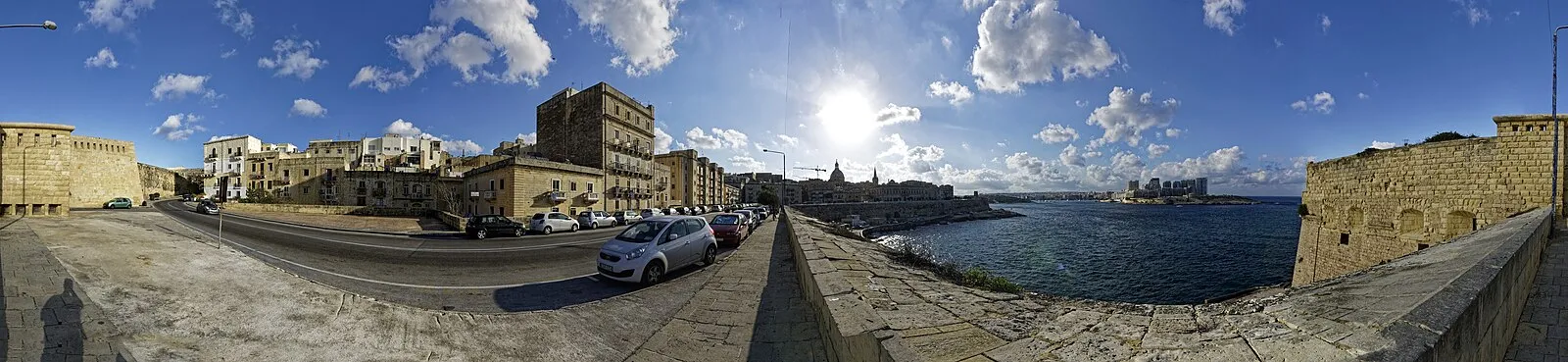 Valletta harbor wall panorama showing the fortified city skyline with basilica dome across the water