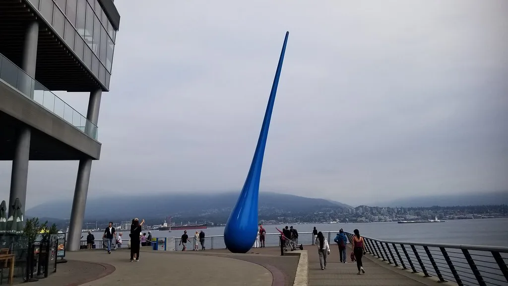 Vancouver harbor waterfront with cruise ships docked at Canada Place and mountain backdrop