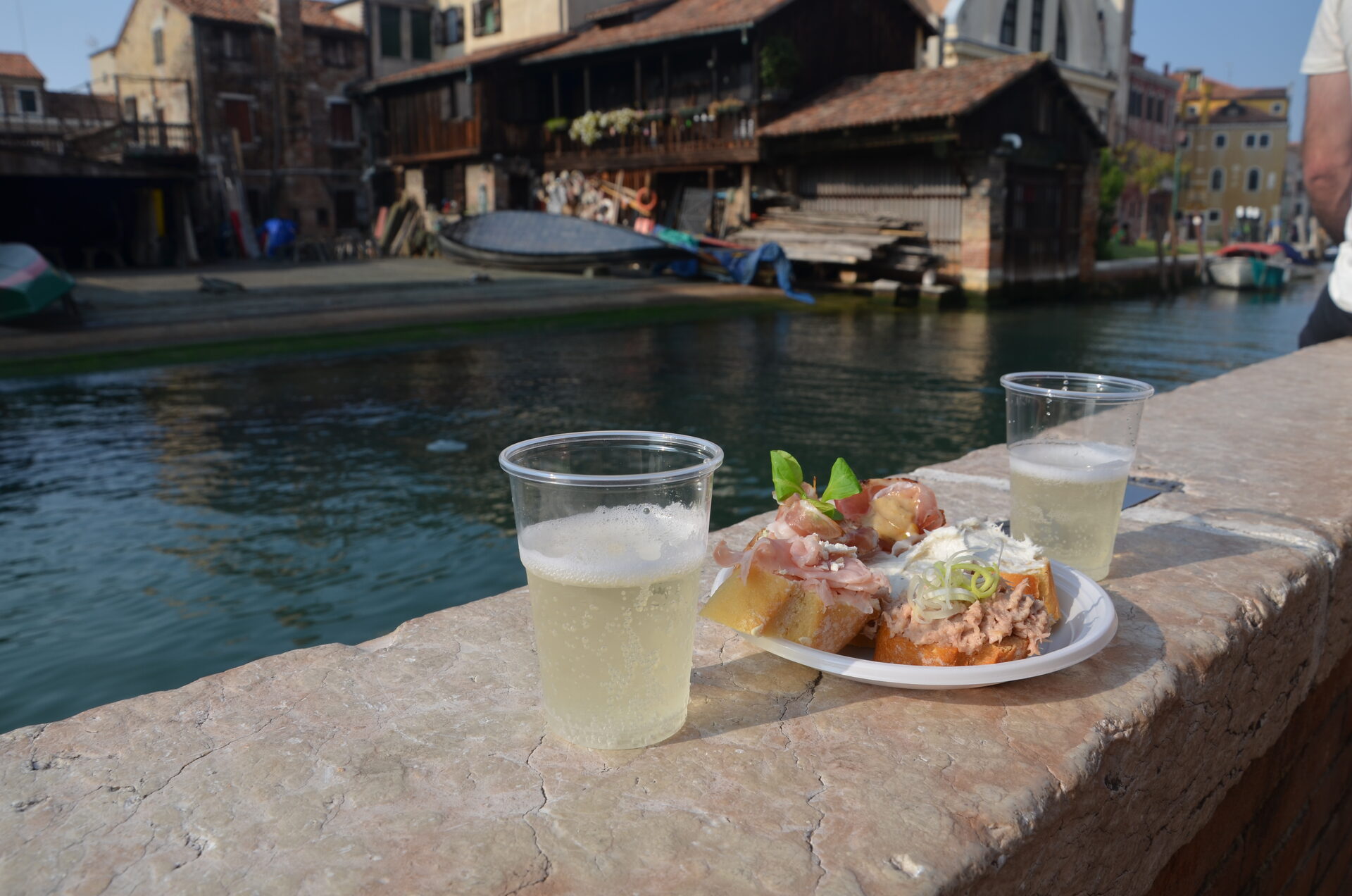 St. Mark's Square at golden hour with the Campanile bell tower and Byzantine domes of the Basilica