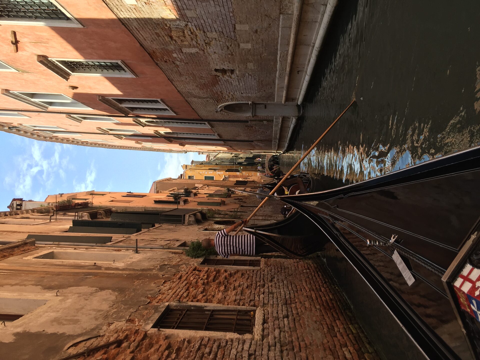 The ornate Gothic facade of the Doge's Palace with its pink marble and white stone arcades