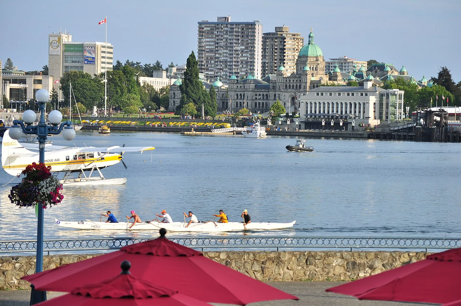 Victoria's Inner Harbour with outrigger canoe team, float planes, and BC Parliament buildings