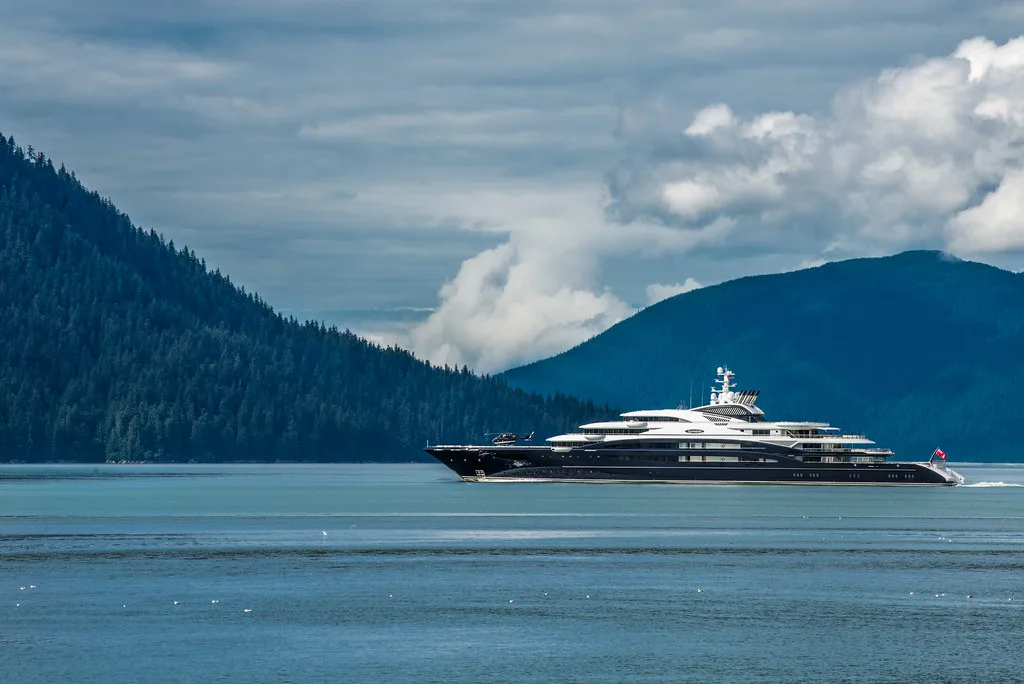 Wrangell harbor with boats moored along the waterfront and forested mountains behind