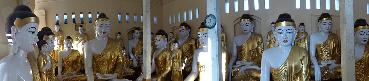 Panoramic view of Yangon skyline with golden Shwedagon Pagoda dominating the horizon at dusk