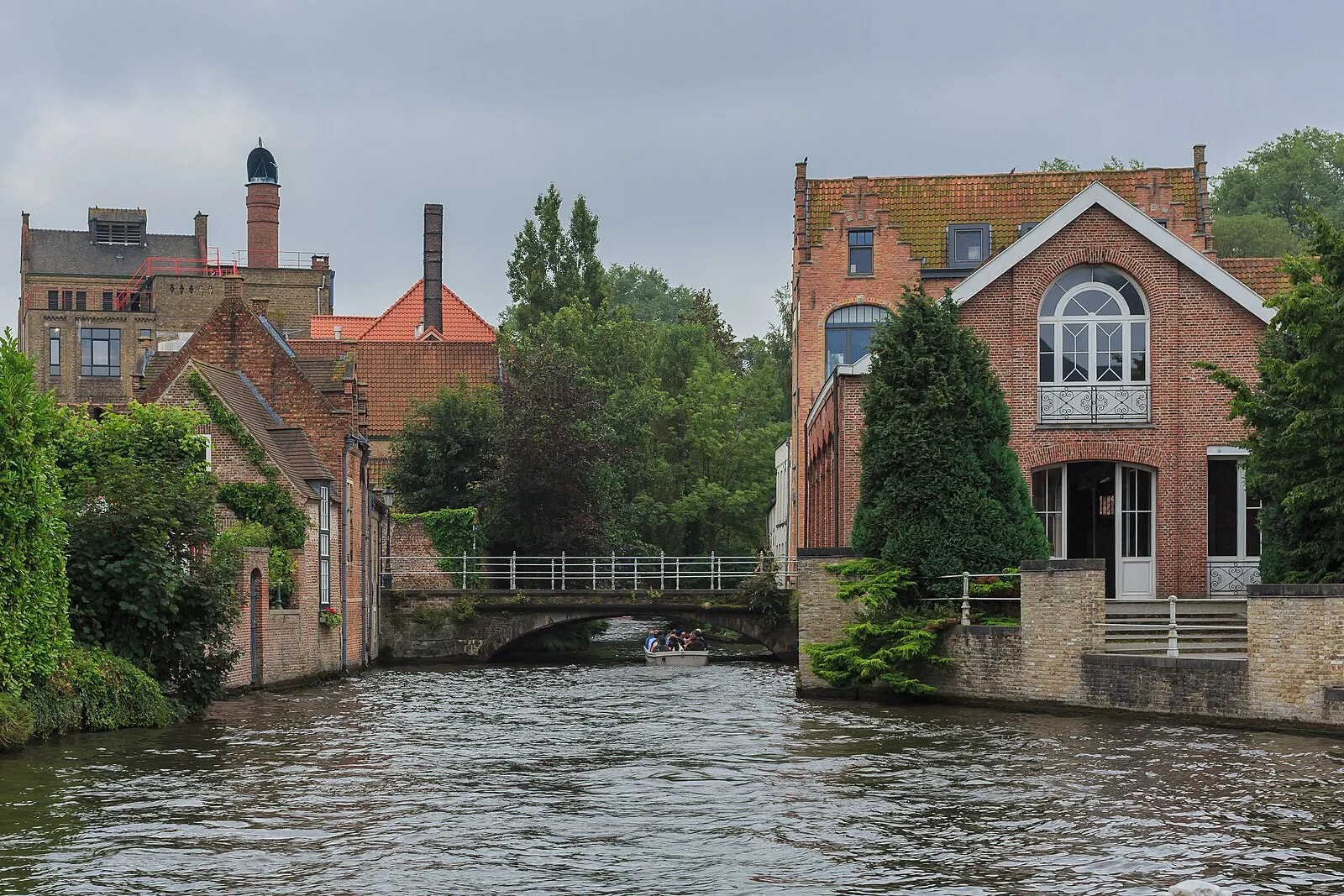 Canal in Bruges with brick buildings and stone bridge